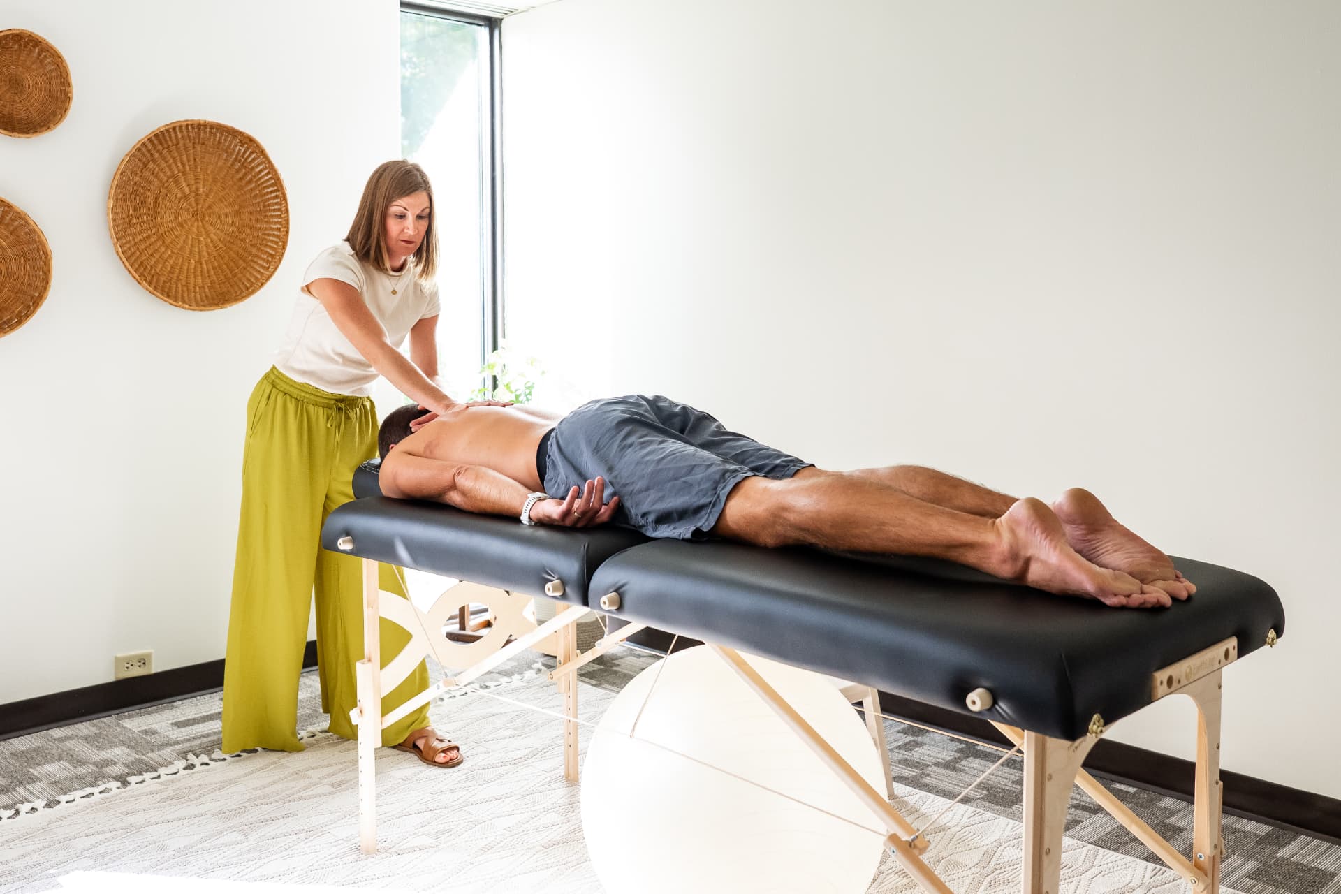 Sarah Missal, RN, providing a hands-on Myofascial Release session in her Sioux Falls studio.